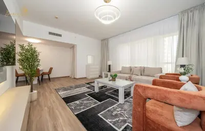 a living room with a couch and a table at Deluxe Beach Residence 2Bhk, 8pax in Dubai