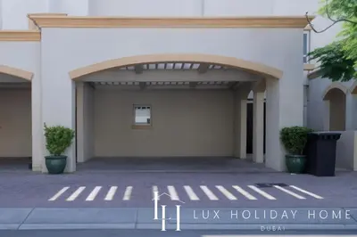 a garage with an open door with the words lux holiday home at LUX The Serene Springs Villa in Dubai