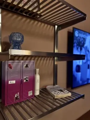 a shelf with a purple refrigerator and a vase on it at Modern Japanese and Arabic Fusion City Stay that is 10 min from Dubai Mall in Dubai