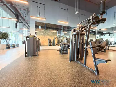 a gym with rows of treadmills and machines at Best Studio facing Burj Khalifa in Dubai