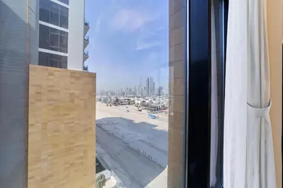 a view of the beach from a window of a building at Elegant 2BR Getaway in Azizi Riviera Near Downtown in Dubai