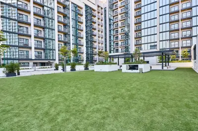 a large yard in front of a large apartment building at STAY BY LATINEM Luxury 1BR Holiday Home CA 1605 Near Burj Khalifa in Dubai