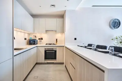a kitchen with white cabinets and a counter top at STAY BY LATINEM Luxury 1BR Holiday Home CA 1605 Near Burj Khalifa in Dubai