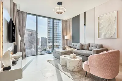 a living room with a couch and a tv at STAY BY LATINEM Luxury 1BR Holiday Home CA 1605 Near Burj Khalifa in Dubai