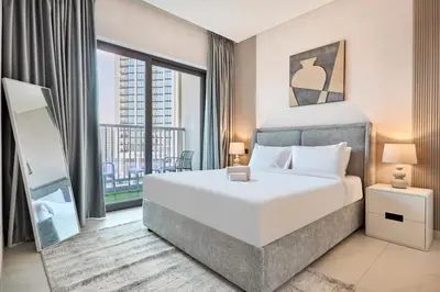 a bedroom with a large bed and a large window at STAY BY LATINEM Luxury 1BR Holiday Home CA 1605 Near Burj Khalifa in Dubai