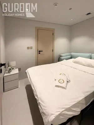 a bedroom with a large bed with a white blanket at Amazing 4 BR on Palm Jumeirah with super sea view in Dubai