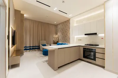 a kitchen with a sink and a stove top oven at Designer Apartment 34-56 with Private Jacuzzi in JVC in Dubai