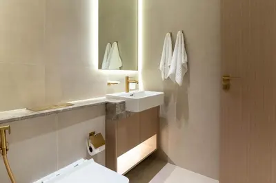 a bathroom with a white sink and a mirror at Designer Apartment 34-56 with Private Jacuzzi in JVC in Dubai