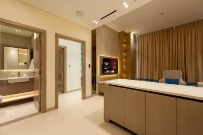 a bathroom with a sink and a counter with chairs at Designer Apartment 34-56 with Private Jacuzzi in JVC in Dubai