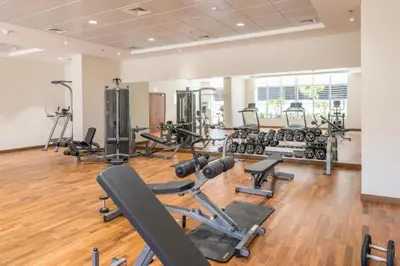 a gym with several exercise bikes and treadmills at Urban Elegance 1BDR in Dunya 06 in Dubai