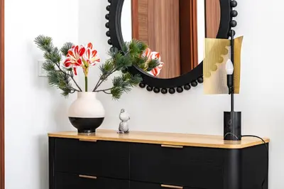 a black and white vase on a dresser with a mirror at Downtown Dubai - Bright 1BR Apartment - Imperial Avenue in Dubai