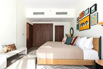 a bedroom with a bed and a couch at Downtown Dubai - Bright 1BR Apartment - Imperial Avenue in Dubai