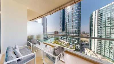 a balcony with chairs and a view of a city at Vacationer l Cozy 1 Bed l Partial Sea View l Prime Location in Dubai