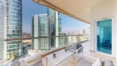an apartment balcony with a view of the city at Vacationer l Cozy 1 Bed l Partial Sea View l Prime Location in Dubai