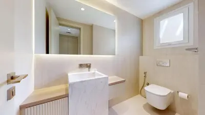 a bathroom with a toilet and a sink and a window at Vacationer l Opulent 2 Bedroom Villa l Private Plunge Pool in Dubai