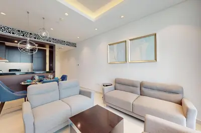 a living room with a couch and a table at Vacationer I Premium 2 Bedroom Apartment I Iconic Burj Khalifa View I Downtown I Distinction Tower in Dubai