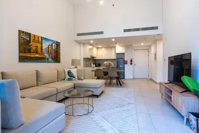 a living room with a couch and a table at Jumeirah Stay Near To Beach in Dubai