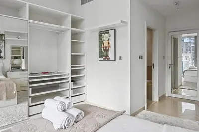 a white bedroom with white towels on the floor at Ultra-Luxury 3BR -Full Sea & Marina Views - JBR in Dubai