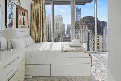 a bedroom with a white bed and a large window at Ultra-Luxury 3BR -Full Sea & Marina Views - JBR in Dubai