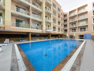 a swimming pool in the middle of a building at Spacious 1BR Magnolia 1 JVC in Dubai