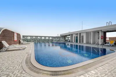 a large swimming pool on top of a building at Amazing Studio Glitz 1 Dubai Studio city in Dubai