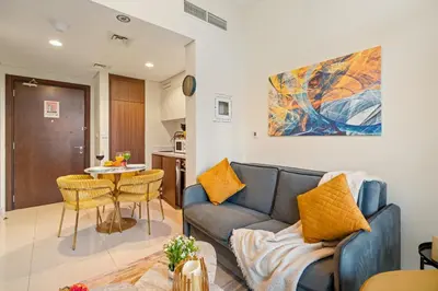 a living room with a couch and a table at Stylish 1BR Burj Khalifa Fireworks View - Reva Residence in Dubai