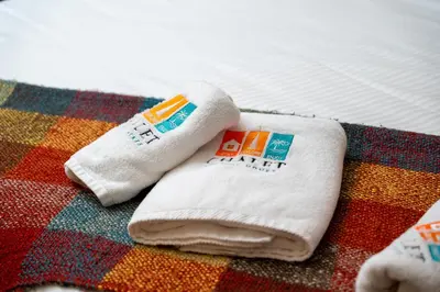 two white towels sitting on top of a bed at Stylish 1BR Burj Khalifa Fireworks View - Reva Residence in Dubai