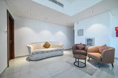 a living room with two chairs and a couch at Balcony Breeze O2 with amazing high way view in Dubai