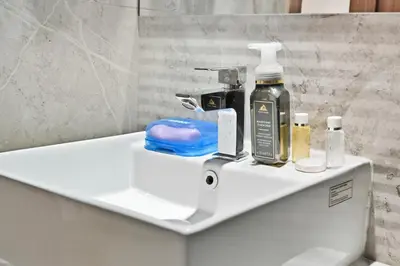 a bathroom sink with a soap dispenser on it at Bloomfields Comfort Studio at Bali Residence, DXB in Dubai