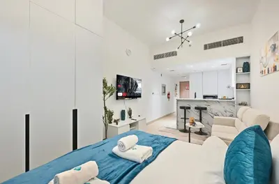 a bedroom with a bed and a living room at Bloomfields Comfort Studio at Bali Residence, DXB in Dubai