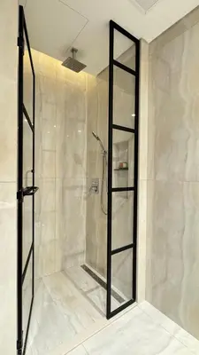 a shower with a glass door in a bathroom at Huge Luxury Waterfront Duplex in Peninsula 5 in Dubai