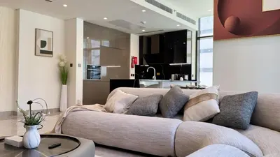 a living room with a couch and a table at Huge Luxury Waterfront Duplex in Peninsula 5 in Dubai