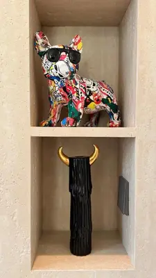 a shelf with a statue of a dog with sunglasses at Huge Luxury Waterfront Duplex in Peninsula 5 in Dubai