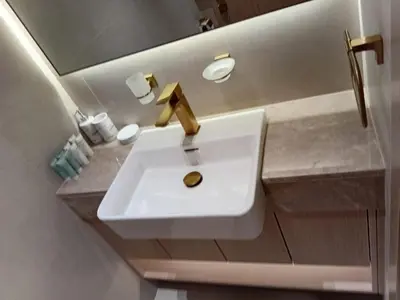 a white sink in a bathroom with a mirror at The Executive Suite Luxury 1 Bedroom Brand New in Dubai