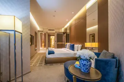 a hotel room with a bed and a table and chairs at City View 1 BR - Creek Heights, Upgraded by UDH in Dubai