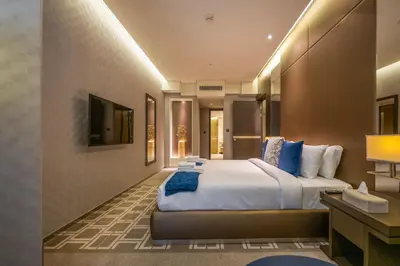 a hotel room with a large bed and a desk at City View 1 BR - Creek Heights, Upgraded by UDH in Dubai