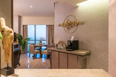 a kitchen and dining room with a table with a microwave at City View 1 BR - Creek Heights, Upgraded by UDH in Dubai