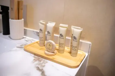 a group of four products on a tray on a counter at Airstay - Upgraded Studio - Near Pool & Metro - Monthly Offer Available! in Dubai