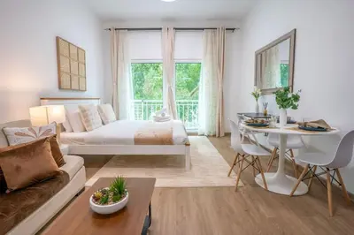 a living room with a bed and a table at Airstay - Upgraded Studio - Near Pool & Metro - Monthly Offer Available! in Dubai