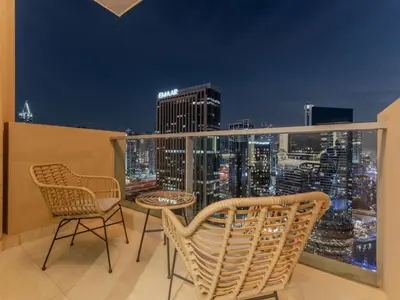 a balcony with chairs and a table and a city skyline at Luxury Views at The Address Dubai Marina in Dubai