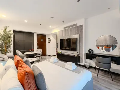a bedroom with a large bed and a living room at Luxury Views at The Address Dubai Marina in Dubai