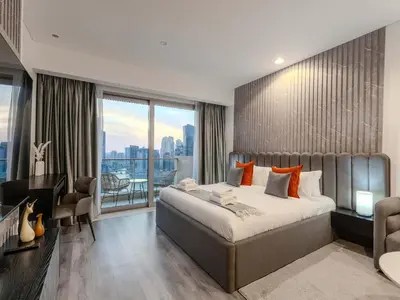 a bedroom with a large bed and a large window at Luxury Views at The Address Dubai Marina in Dubai