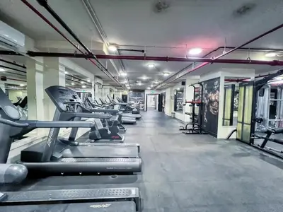 a gym with rows of treadmills and machines at GuestReady | Studio | Partial Burj Khalifa View in Dubai