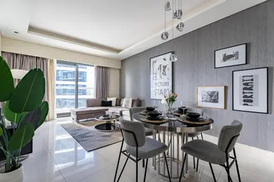 a living room with a table and chairs at GuestReady - Chic Damac Paramount | Business Bay in Dubai
