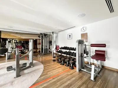 a gym with a bunch of equipment in a room at GuestReady - Chic Damac Paramount | Business Bay in Dubai