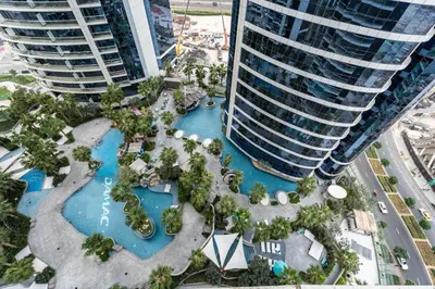 an aerial view of a resort with two tall buildings at GuestReady - Chic Damac Paramount | Business Bay in Dubai