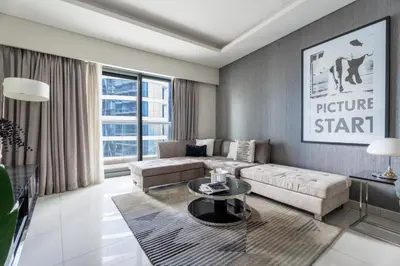 a living room with a couch and a table at GuestReady - Chic Damac Paramount | Business Bay in Dubai