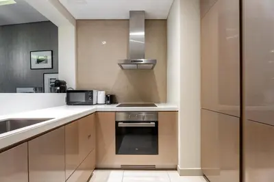 a kitchen with a sink and a stove at GuestReady - Chic Damac Paramount | Business Bay in Dubai
