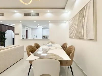 a dining room with a table and chairs at Dream Shoma-2BR - Pool - Walk to Burj Khalifa in Dubai