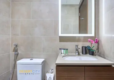 a bathroom with a sink and a mirror at Stylish and Sophisticated Home Near Downtown Dubai Hosted by Desert City Stays in Dubai